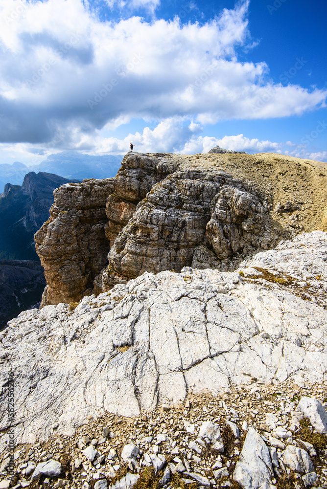 Rear view of a man on a cliff of Little Lagazuoi peak Dolomites UNESCO Italian Alps landscape