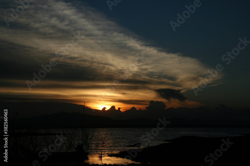 sunset over the lake in nation park, Beautiful rainforest landscape with fog in evening Thailand