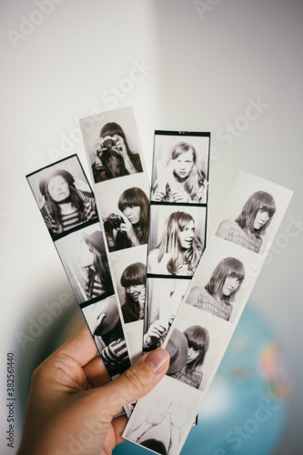 Hand holding photobooth strips photo