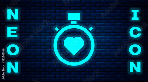 Glowing neon Heart in the center stopwatch icon isolated on brick wall background. Valentines day. Vector.