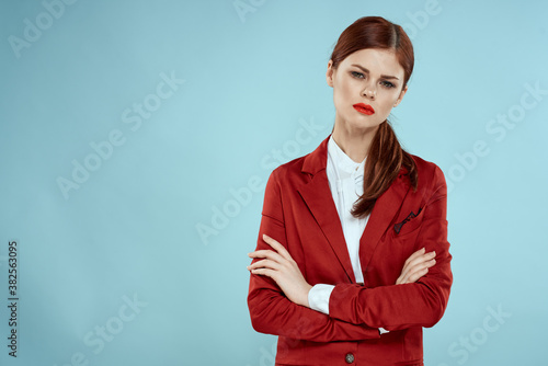 Elegant woman in red jacket bright makeup lips self-confidence cropped view blue background