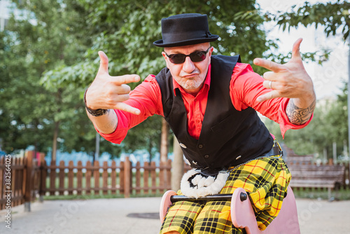 Canvastavla Weird man with bowler hat over a children's toy, man wearing kilts and Scottish