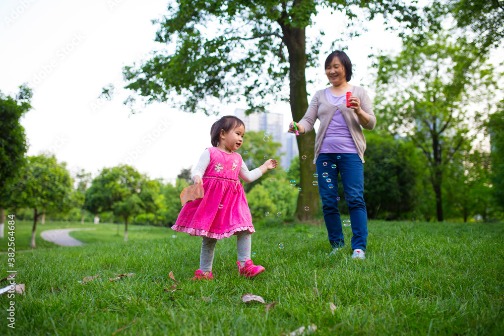 lovely little asian girl having good time outdoor with her grandmother lovely little asian girl having good time outdoor with her grandmother