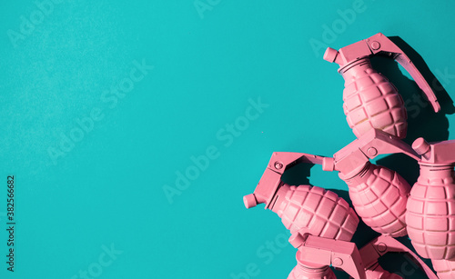 Pink hand grenades on blue background.