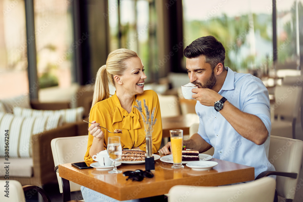 Happy couple enjoying in cup of coffee and dessert in a cafe. Happy couple enjoying in cup of coffee and dessert in a cafe.