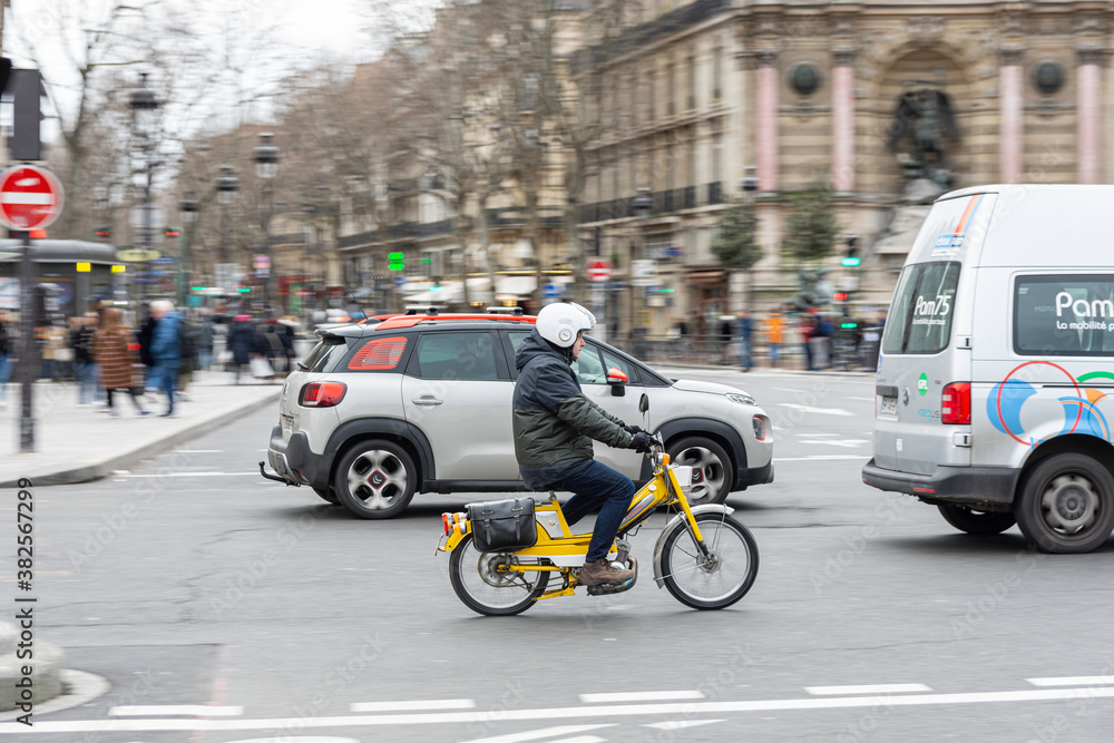 Paris, France; January 10, 2020: Classic nice moped running in the city. 