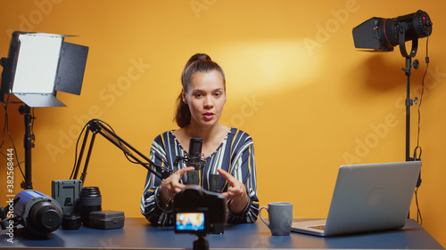 Professional NP-F battery review by new media star in her studio set. Content creator new media star influencer on social media talking professional video photo equipment for online internet web show photo