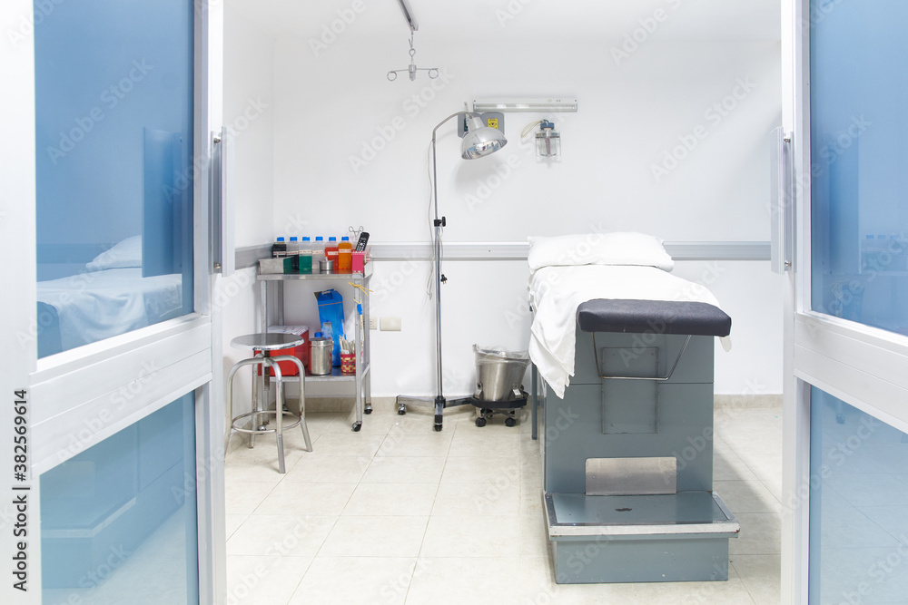 © Per Swantesson/Stocksy - Examination room with bed in a hospital