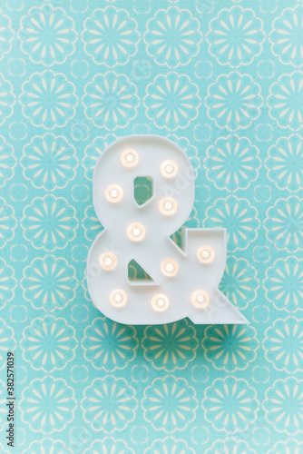 Ampersand marquee light on a blue background photo