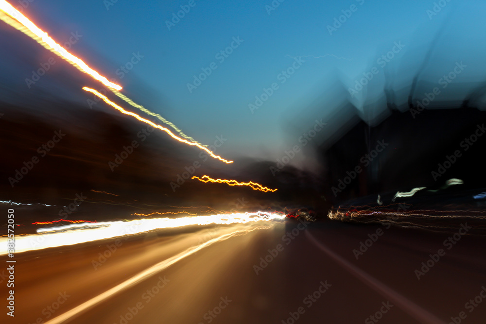 Long exposure trails of cars on the road during evening - shaking effect of light trails