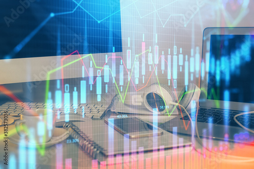 Financial chart drawing and table with computer on background. Double exposure. Concept of international markets.