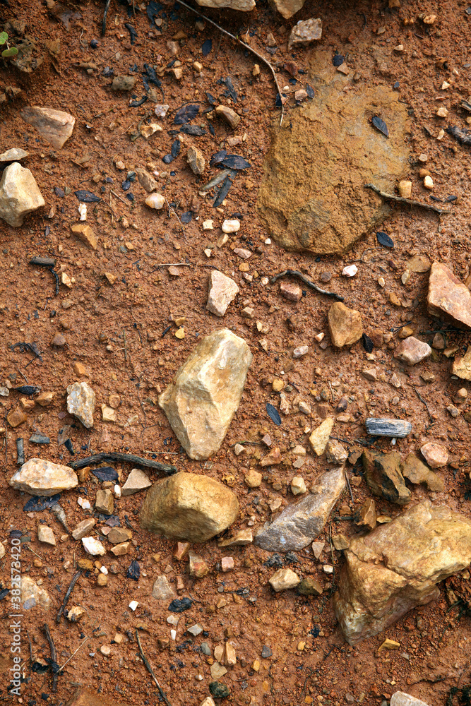 Moist yellow soil with lots of small stones, detailed texture Moist yellow soil with lots of small stones, detailed texture