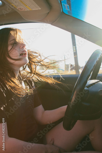 teenage driver driving with window down photo