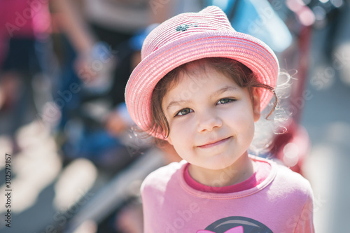 Portrait of a cute little girl wearing a pink hat