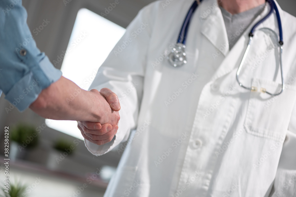 Handshake between doctor and patient Handshake between doctor and patient