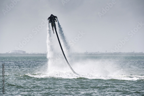 Beach holiday goes high tech - Man having a thrill with a rented water jet pack