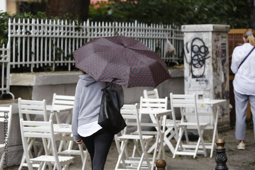 Woman with umbrella walking on a rainy day