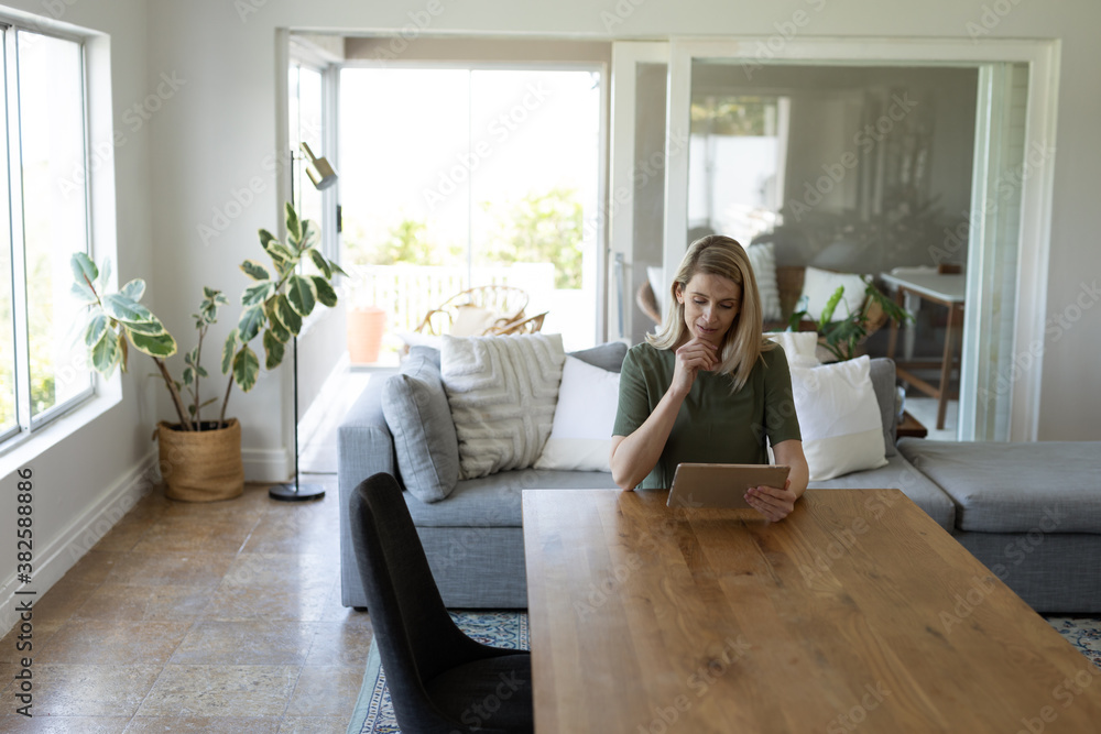 Woman using digital tablet at home Woman using digital tablet at home
