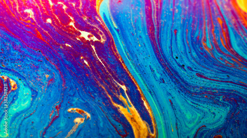 Abstract colorful background. Colored waves of paint with veins.