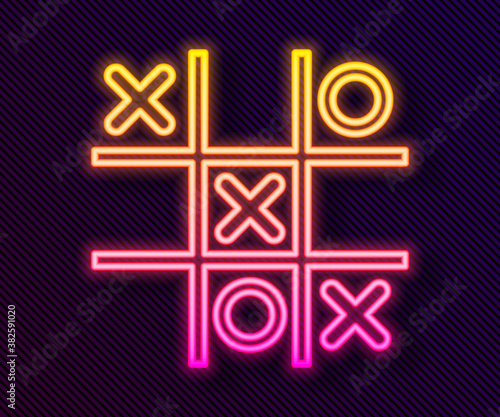 Glowing neon line Tic tac toe game icon isolated on black background. Vector.