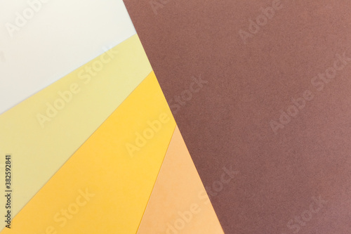 Abstract colorful paper backgroud. Dark brown, beige, orange, yellow and light paper background