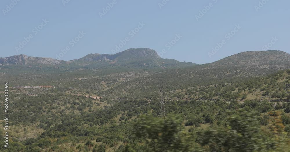 2 shots Montenegro. Beautiful video of the mountains where you can see the tops of trees, bushes, rocks, the road on which cars drive. The video was shot while driving from the car. 2 shots Montenegro. Beautiful video of the mountains where you can see the tops of trees, bushes, rocks, the road on which cars drive. The video was shot while driving from the car.