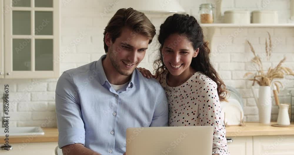Pretty caucasian spouses in cozy domestic kitchen using portable computer search house renovation ideas on internet, buying goods, make order and delivery using easy comfort services on-line concept Pretty caucasian spouses in cozy domestic kitchen using portable computer search house renovation ideas on internet, buying goods, make order and delivery using easy comfort services on-line concept
