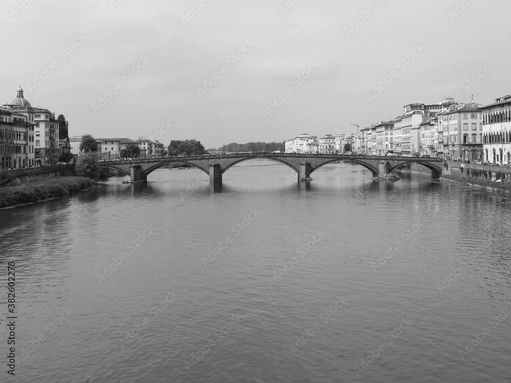 Florence, Italy - October 1 2006 - A black and white view of Ponte alle Grazie, originally named Ponte di Rubaconte, a bridge over the Arno River in Florence, Italy.  Image has copy space.
