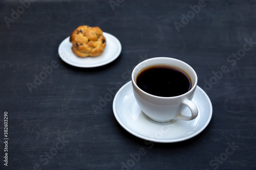 Top view of tea and handmade cookie on black table