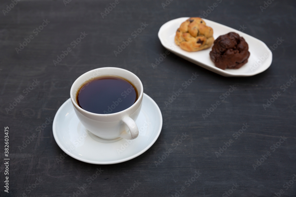 Top view of tea and handmade cookie on black table Top view of tea and handmade cookie on black table