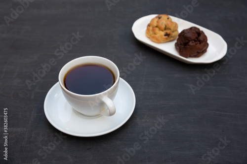 Top view of tea and handmade cookie on black table