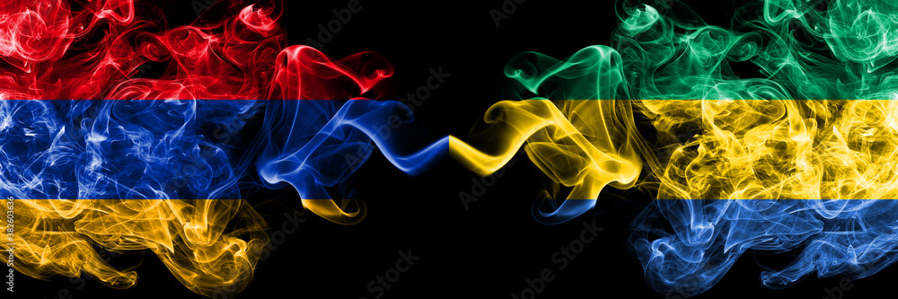 Fototapeta premium Armenia vs Gabon, Gabonese smoky mystic flags placed side by side. Thick colored silky abstract smoke flags