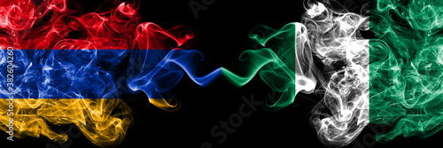 Armenia vs Nigeria, Nigerian smoky mystic flags placed side by side. Thick colored silky abstract smoke flags
