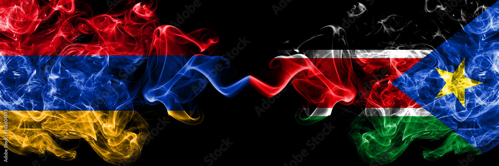 Armenia vs South Sudan smoky mystic flags placed side by side. Thick colored silky abstract smoke flags