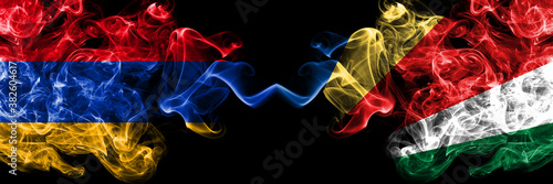 Armenia vs Seychelles, Seychelloise smoky mystic flags placed side by side. Thick colored silky abstract smoke flags