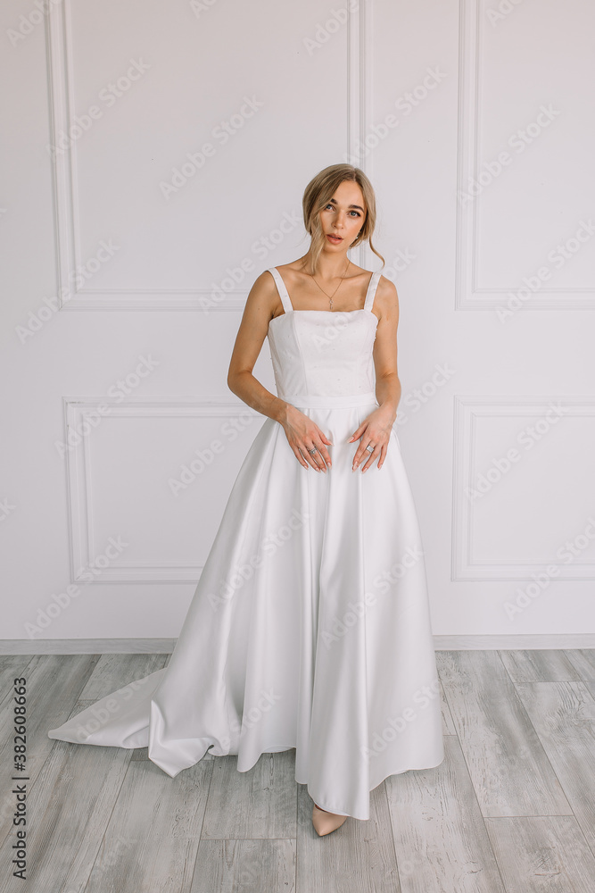 young woman in a white wedding dress with long hair before the engagement ceremony on a white background with a model appearance important wife for the bride posing in front of the photographer
young woman in a white wedding dress with long hair before the engagement ceremony on a white background with a model appearance important wife for the bride posing in front of the photographer