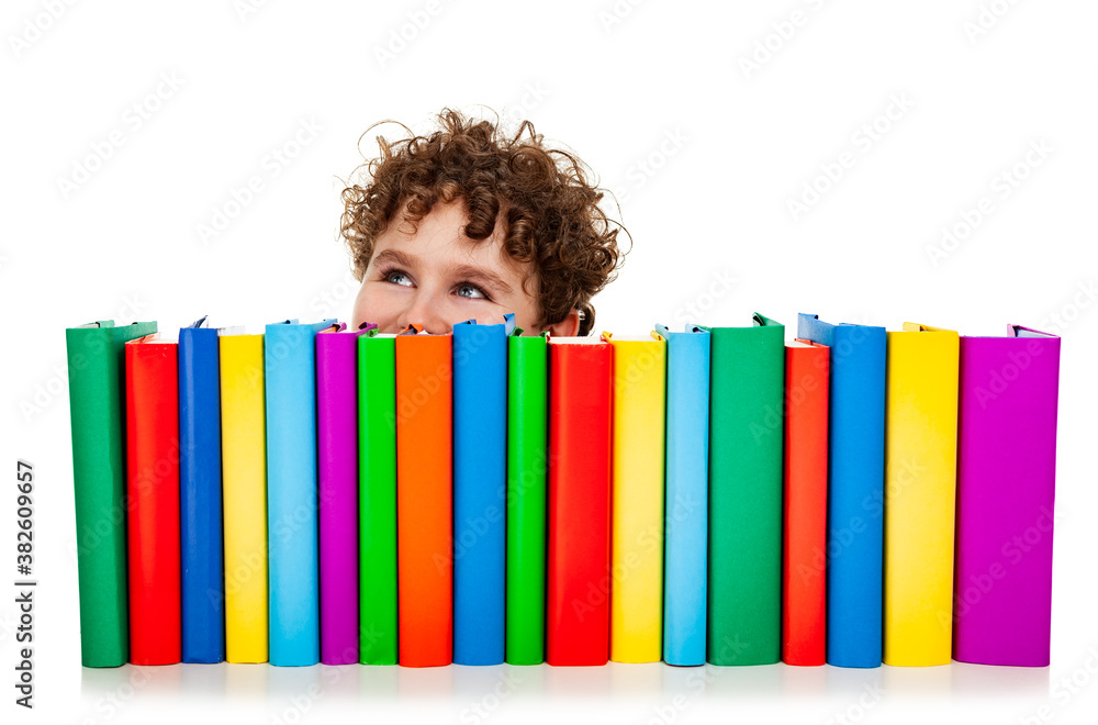 Boy behind pile of books isolated on white background
Boy behind pile of books isolated on white background