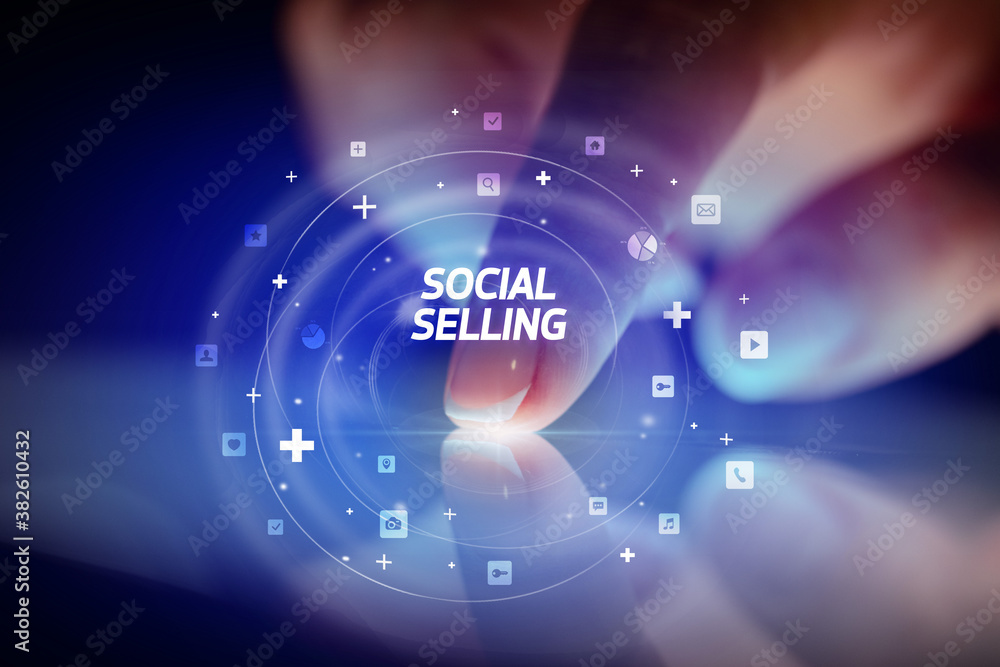 Finger touching tablet with social media icons and SOCIAL SELLING
