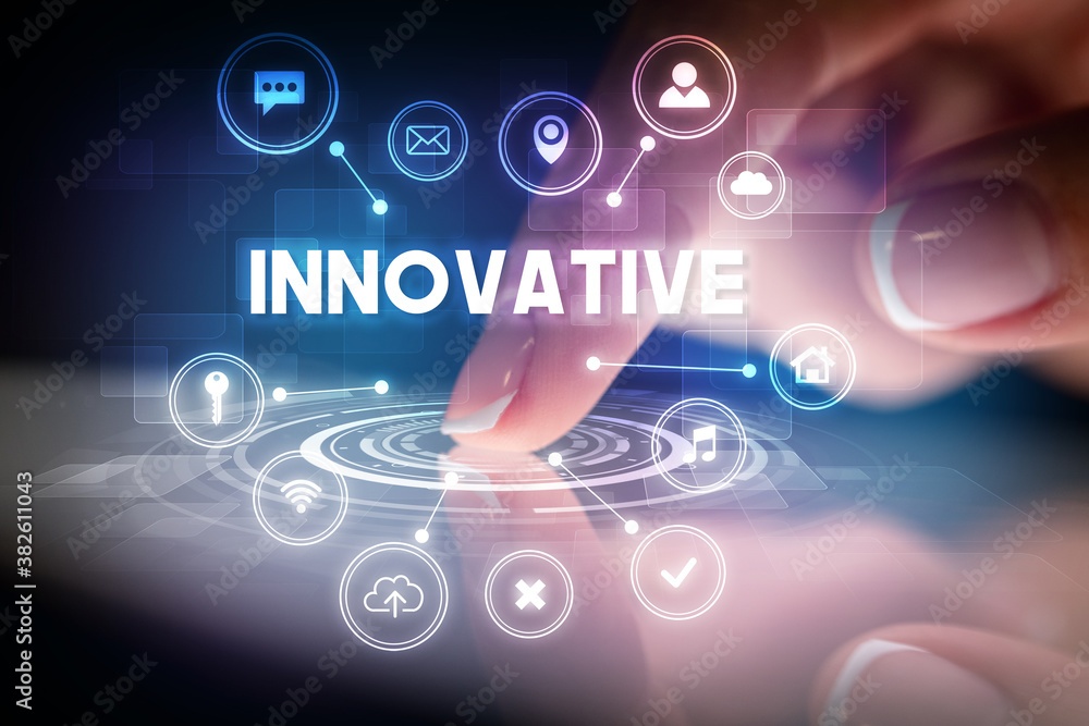 Finger touching tablet with web technology icons and INNOVATIVE inscription, web technology concept Finger touching tablet with web technology icons and INNOVATIVE inscription, web technology concept