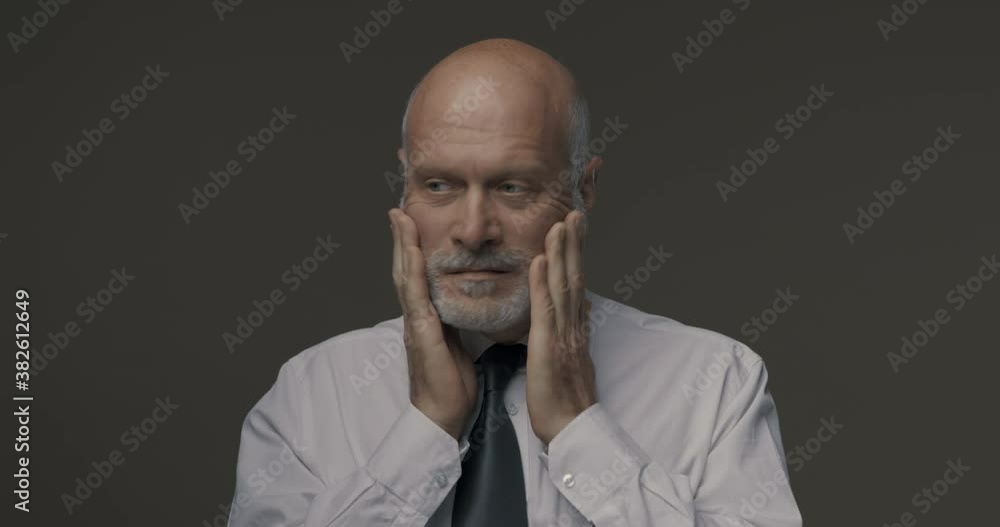 Confused pensive businessman thinking and looking away Confused pensive businessman thinking and looking away
