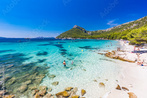 Platja de Formentor, Mallorca, Spain - July 20, 2020: People enjoying popular beach in summer, Mallorca, Spain. photo