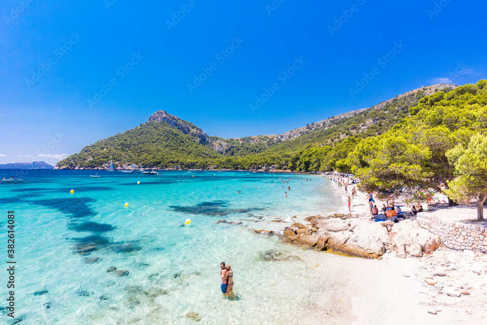 Platja de Formentor, Mallorca, Spain - July 20, 2020: People enjoying popular beach in summer, Mallorca, Spain.