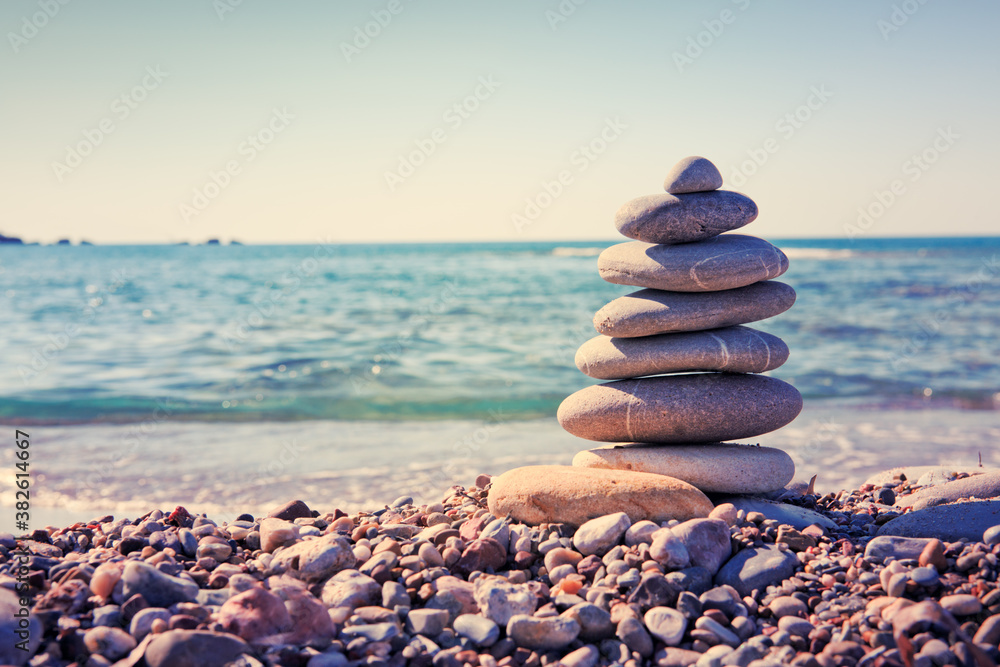 Spa gray stones balance on summer beach.