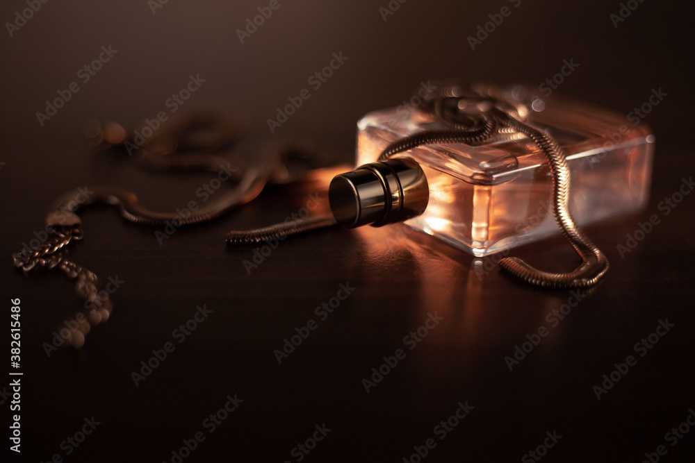 Perfume bottle and accessories on dark background Perfume bottle and accessories on dark background