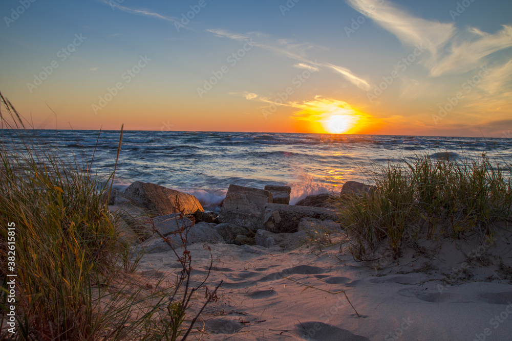Summer Lake Sunset Landscape. Beautiful sunset beach horizon on the coast of Lake Michigan on the Great Lakes shoreline.