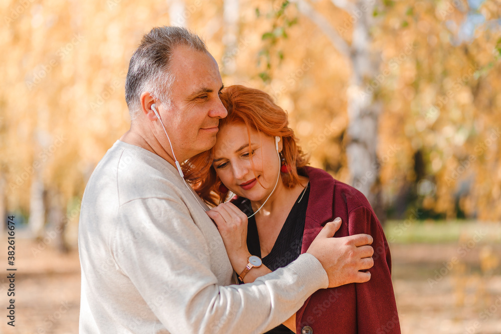 Fototapeta premium middle-aged man and woman with headphones