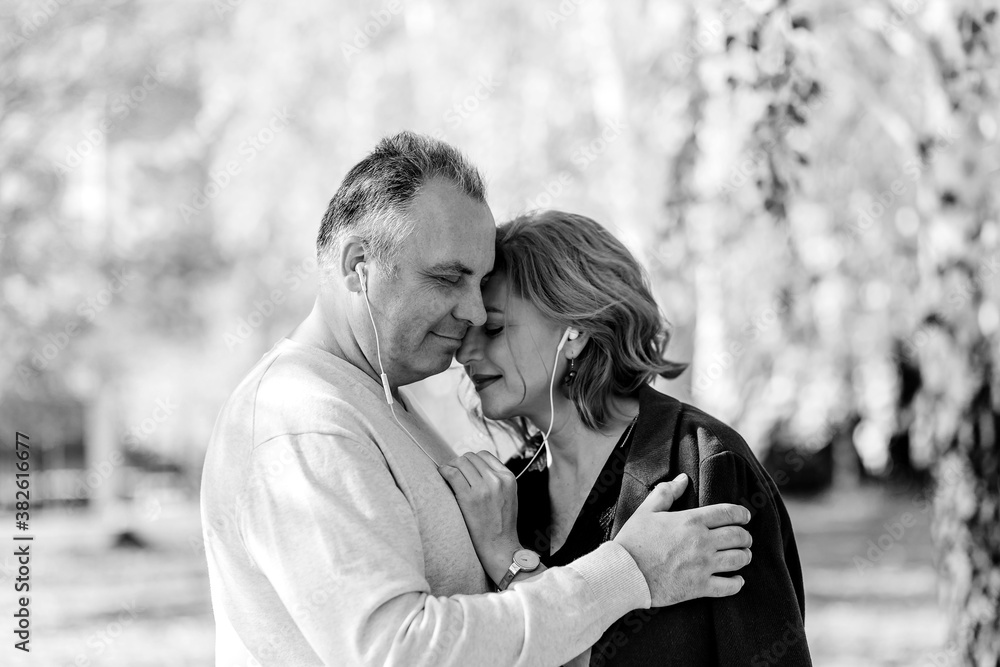 middle-aged man and woman with headphones middle-aged man and woman with headphones