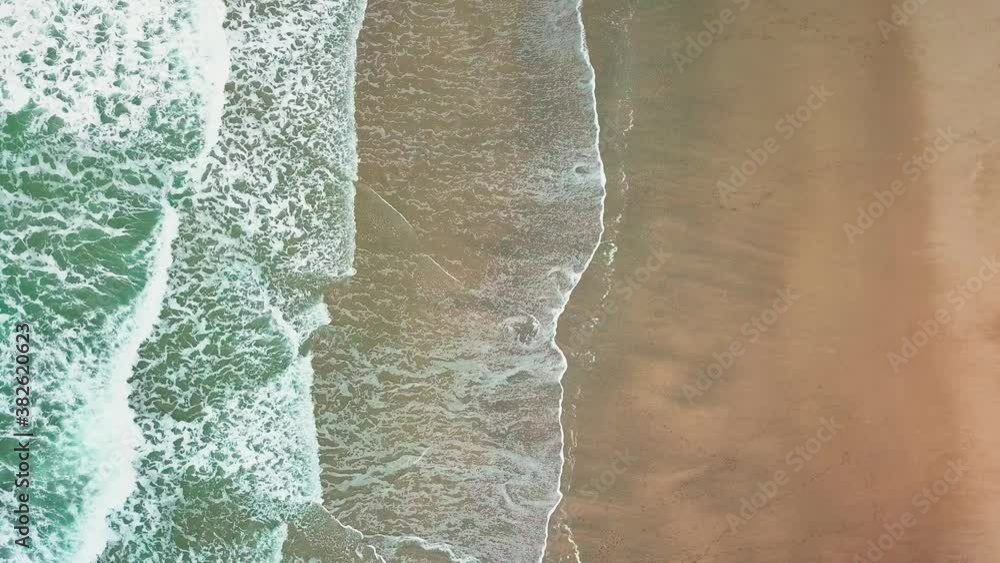Beautiful bright waves rolling on the beach - top view Beautiful bright waves rolling on the beach - top view
