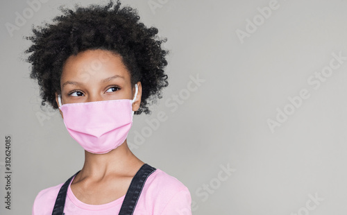 Little girl wearing face mask protective for spreading of Coronavirus. Masked child isolated portrait. Epidemic, pandemic, corona virus protection, healthy lifestyle concept © kite_rin