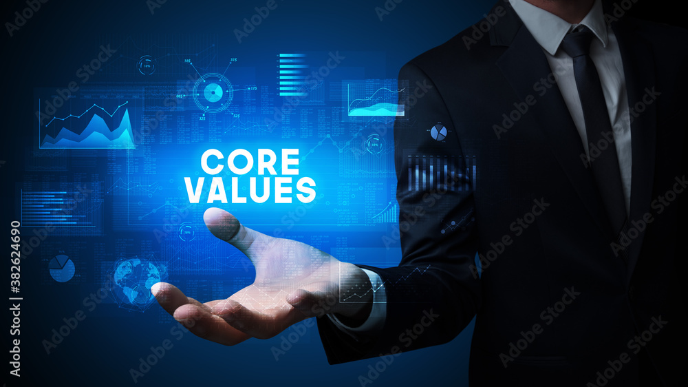 Hand of Businessman holding CORE VALUES inscription, business success concept Hand of Businessman holding CORE VALUES inscription, business success concept